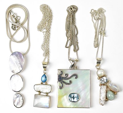 Lot 816 - Four pendants, comprising a large...