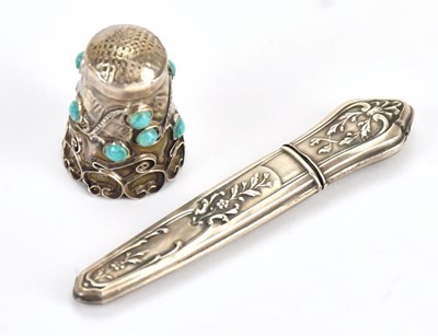 Lot 215 - A Continental white metal thimble set with...