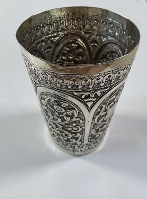 Lot 554 - An Indian white metal beaker, with decorative...