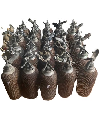 Lot 46 - Thirty glass and mesh soda syphons with metal...
