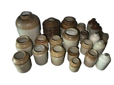 Lot 51 - Twenty one stoneware jars and bottles,...
