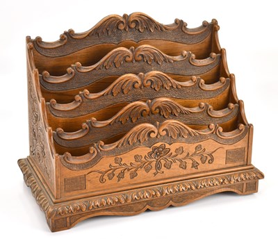 Lot 2014 - A decorative Black Forest carved walnut four...