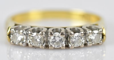 Lot 441 - A diamond five stone dress ring in yellow...