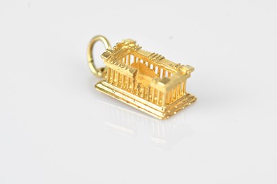 Lot 29 - A yellow metal charm of classical ruins,...
