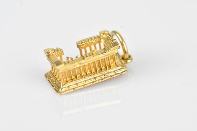 Lot 29 - A yellow metal charm of classical ruins,...