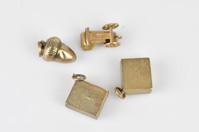 Lot 18 - Three 9ct gold novelty charms, including a £10...