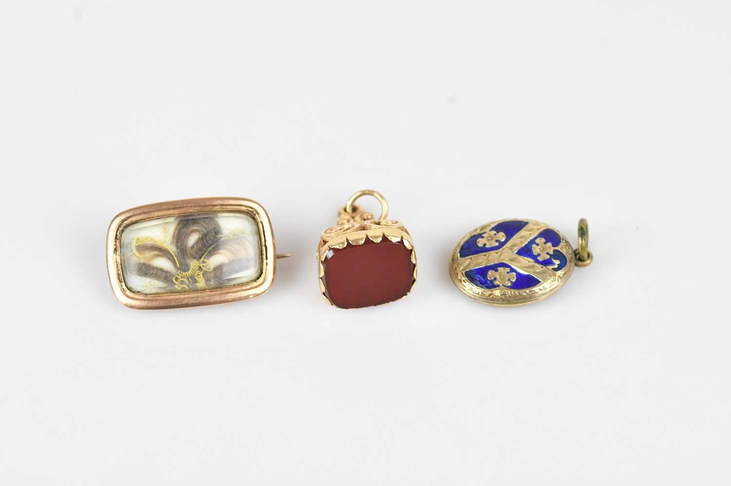 Lot 17 - A 19th century oval mourning brooch in yellow...