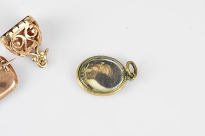 Lot 17 - A 19th century oval mourning brooch in yellow...