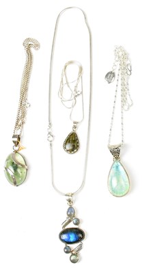 Lot 817 - Four silver pendants, comprising an oval...