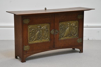 Lot 2119 - An Arts and Crafts oak cabinet in the manner...