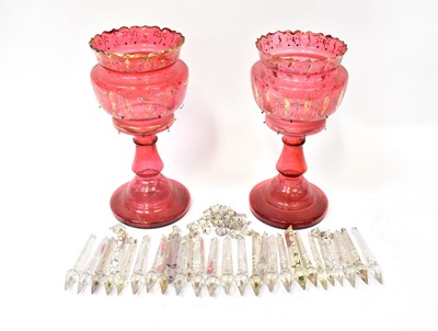 Lot 695 - A pair of Victorian cranberry glass lustres...