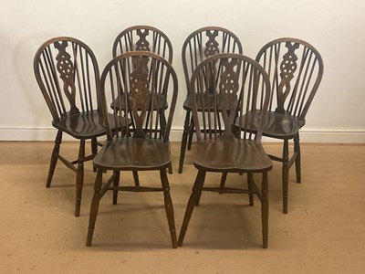 Lot 700 - A set of six stained elm Windsor wheel back...