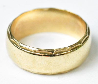 Lot 728 - A 9ct yellow gold wedding band with faceted...
