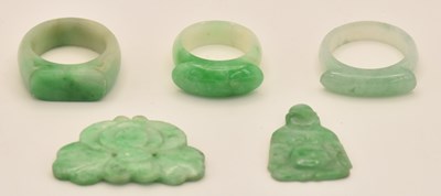 Lot 1530 - Three Chinese carved green jade dress rings,...