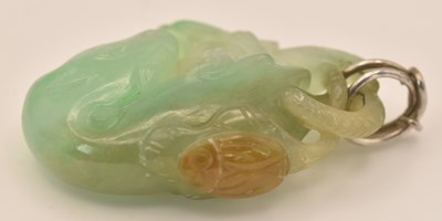 Lot 1011 - A Chinese carved green jade figure of mother...