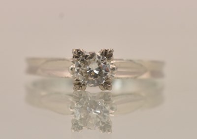 Lot 1253 - An 18K white gold diamond solitaire ring, the...
