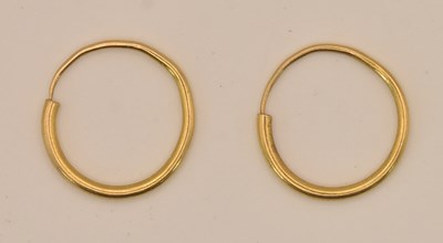 Lot 1226 - A pair of yellow metal sleeper hoops, both...