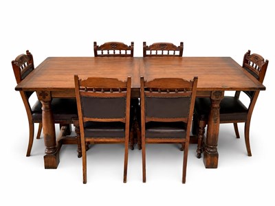 Lot 2097 - A reproduction carved oak extending refectory...