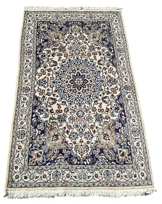 Lot 119 - An Iranian hand woven cream ground Nain rug,...