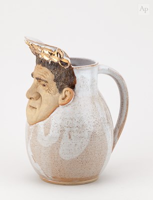 Lot 270 - JIM RANSON; a stoneware character jug, painted...