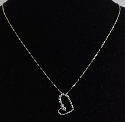 Lot 1378 - An 18ct white gold diamond set heart shaped...