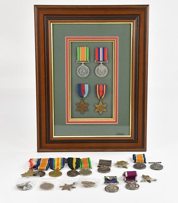 Lot 1229 - A framed montage containing four WWII medals...