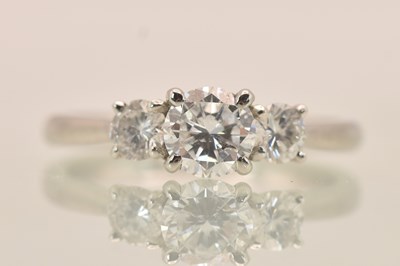 Lot 1234 - A platinum (950) three stone claw set diamond...