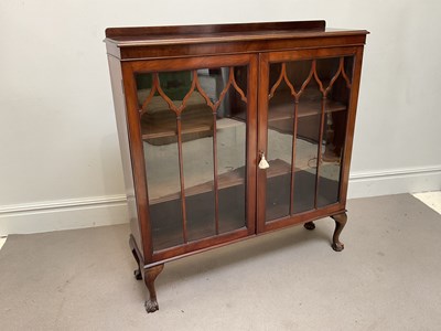 Lot 218 - A 1940s walnut twin door display cabinet,...