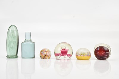 Lot 1219 - A collection of six glass paper weights,...