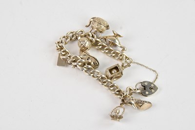 Lot 238 - A hallmarked silver charm bracelet, with seven...