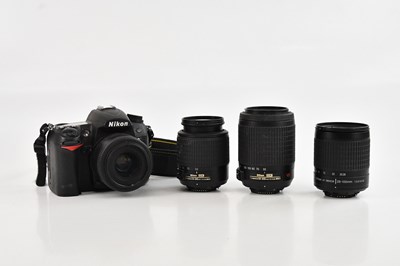 Lot 86 - NIKON; a D7000 DSLR camera, with four lenses,...