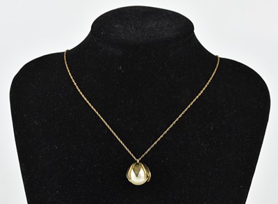 Lot 351 - A simulated pearl pendant suspended on a 9ct...