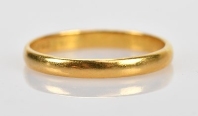 Lot 480 - A 22ct yellow gold wedding band, size M,...