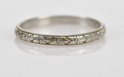 Lot 535 - A platinum wedding band with textured...