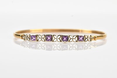 Lot 59 - A 9ct yellow and white gold hinged bangle, set...