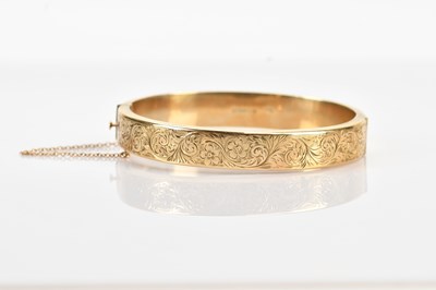 Lot 72 - A 9ct yellow gold hinged snap bangle with...