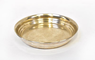Lot 872 - A sterling silver bottle coaster, stamped 925,...