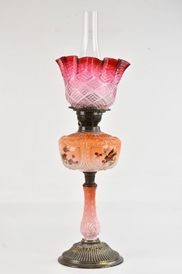 Lot 2350 - An early 20th century oil lamp, with cranberry...