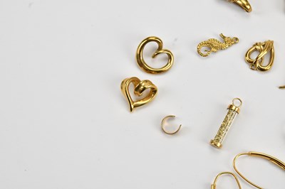 Lot 8 - A yellow metal heart shaped crossover pendant,...