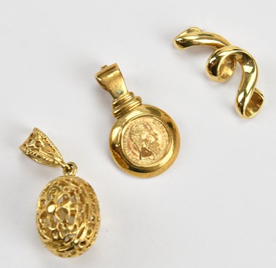 Lot 310 - A yellow metal twist pendant, stamped '14K',...