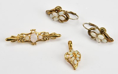 Lot 132 - A 9ct yellow gold opal set bar brooch, set...