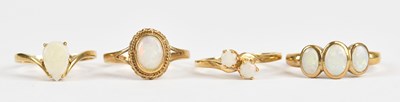 Lot 470 - A 9ct yellow gold opal three stone dress ring,...