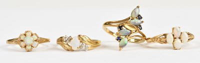 Lot 472 - Four 9ct yellow gold opal set dress rings,...