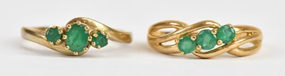 Lot 546 - Two 9ct yellow gold emerald set three stone...