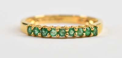 Lot 525 - An 18ct yellow gold emerald set nine stone...