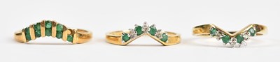 Lot 486 - Two 9ct yellow gold diamond and emerald set...