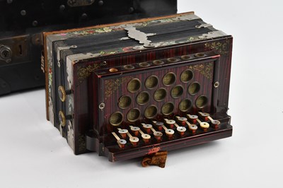 Lot 29 - A vintage button accordion, cased.