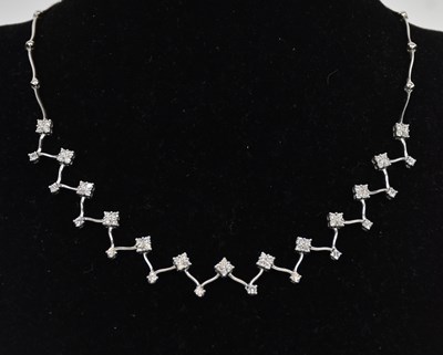 Lot 1360 - An 18ct white gold diamond set necklace, the...