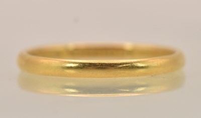 Lot 1325 - A 22ct yellow gold thin band ring, size P,...