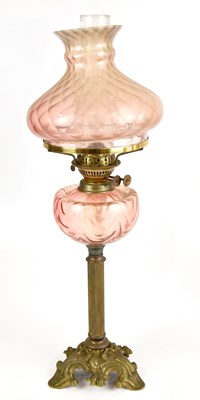 Lot 1499 - An early 20th century brass oil lamp with pink...
